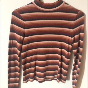 a red, brown and blue-ish sweater
